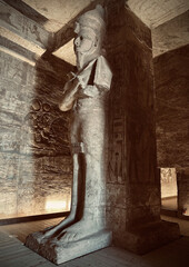 Interior view with giant statues of Ramses II Abu Simbel temple, ancient Egypt