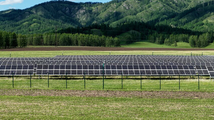 Solar power plant in the mountains. Thousands of solar panels. Renewable energy in remote...