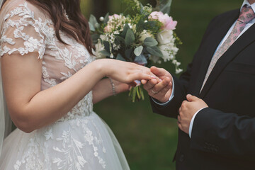 Sensual wedding couple. Romantic moments of newlyweds. Wedding photo. Wedding flowers bouquet held...