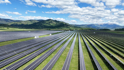 Solar power plant in the mountains. Thousands of solar panels. Renewable energy in remote mountainous regions. Clean energy from the sun. Rows of solar panels at a power plant. © OlTarakanov