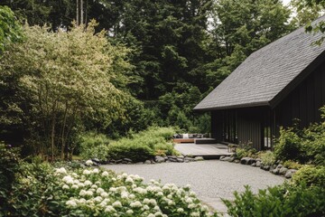 A serene garden oasis showcases a sleek, modern black house harmoniously situated amidst vibrant, lush greenery under the bright daylight