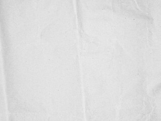 Crumpled textured white paper with subtle folds and creases, perfect for background use in design projects or presentations. The image portrays a natural, slightly wrinkled surface