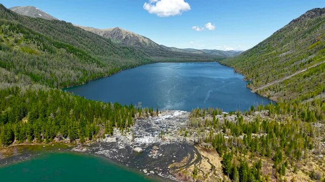 Multinsky lakes of the Altai Republic. Beautiful high-mountain lakes surrounded by mountains, cinematic 4k views from a great height.
