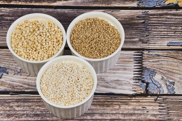 Whole grains concept. A colorful mix of whole grains: wheat, corn, and quinoa. Ingredients for a healthy diet, selective focus.
