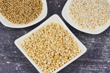 Whole grains concept. A colorful mix of whole grains: wheat, corn, and quinoa. Ingredients for a healthy diet, selective focus.