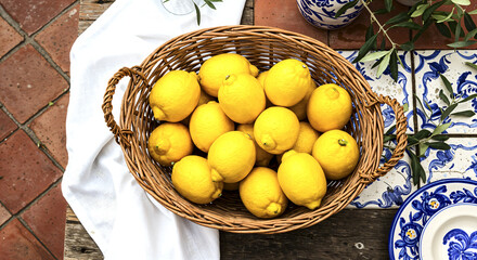 Rustic basket of fresh lemons on mediterranean styled table