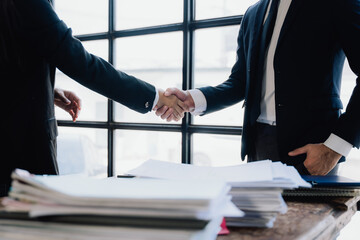 Business Deal Handshake Over Documents