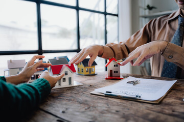 Obraz premium Real Estate Deal with Miniature Houses