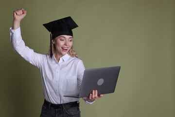 Happy student with laptop after graduation on green background. Space for text