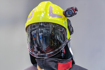 Firefighter in protective gear, wearing an orange helmet with face shield and breathing apparatus...