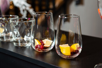Empty Cocktail Glasses with Citrus and Berries.
