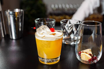 Whiskey Sour Cocktail with Ice and Cherry Garnish.