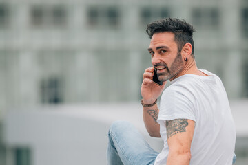 casual style young man on the street with mobile phone