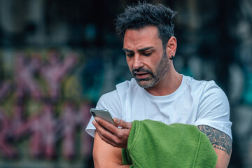 young man on the street with mobile phone