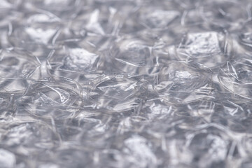 Bubble wrap macro photo with selective focus. It is a pliable transparent plastic material with...