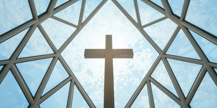Cross set against a geometric glass background under a bright sky. Concept: spirituality and architectural design