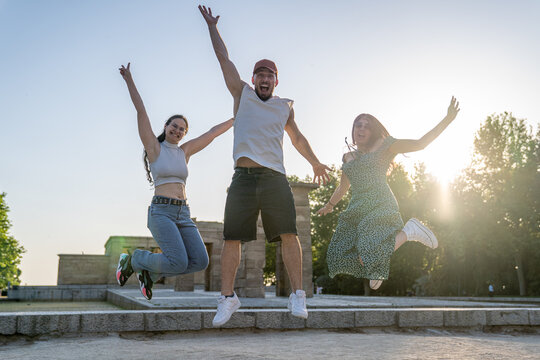 Friends jumping at sunset in front of templo de debod, madrid