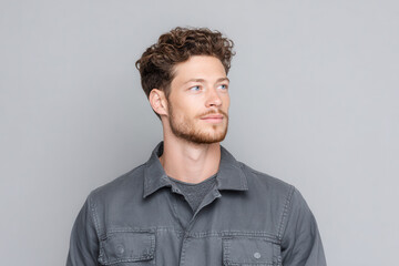Obraz premium portrait of warehouse worker on right side of frame displaying thoughtful expression