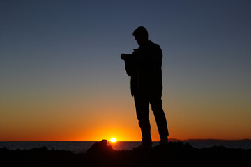 Videographer silhouette at sunset