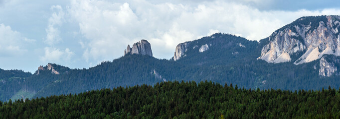 Panoramic view of Egyeskő (Lonely Rock) in Romania’s Hagymás Nature Reserve, with the rockfall known as "Devil’s Mill." High-resolution summer scene with dramatic clouds and rich natural detail.