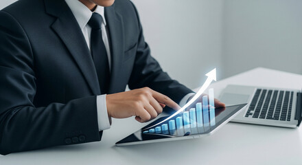 Close-up of businessman using tablet, displaying upward trending graph symbolizing growth, success, and progress in business