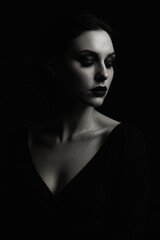 Dramatic shadowed portrait of woman with intense gaze in low light