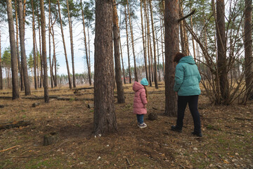 Grandmother and granddaughter walking in the forest