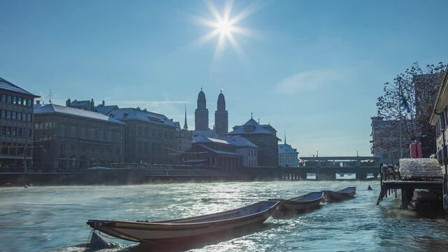 Time lapse, European town covered with snow. Grossmunster in winter. Zurich old town along the Limmat river with the Grossmunster cathedral. Zurich, Switzerland.