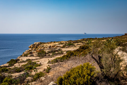 Majestic Limestone Cliffs Overlook Azure Mediterranean Sea in Birzebbuga