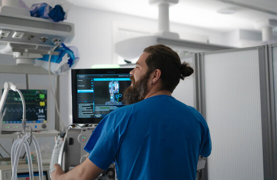 Doctor looking at medical scan on computer screen in hospital operating room