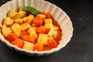 Stewed potatoes with carrots vegetarian side dish fresh delicious gourmet food background on the table rustic food top view copy space keto and paleo diet vegan food