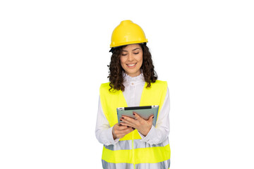 Young woman architect wearing safety helmet and vest holding tablet, looking at it and smiling, isolated on transparent background