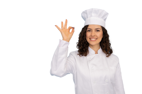 Female chef showing ok sign with hand, wearing white uniform and toque, smiling and posing on a transparent background
