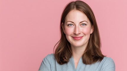 Confident Young Woman Smiling Against a Soft Pink Background
