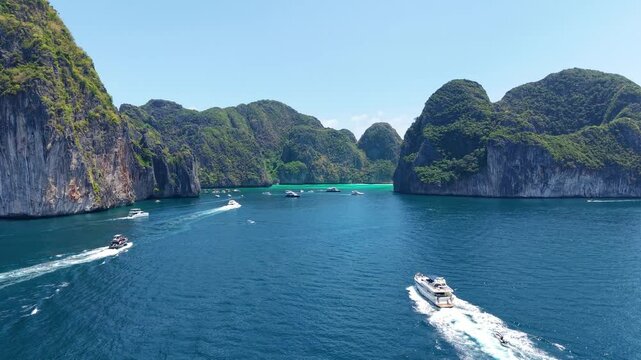 Yacht vacation. White beautiful yacht moving to Phi Phi islands, vacation on board white yacht, drone view 4k. Luxury yacht moving on blue sea, aerial view of vacation shots