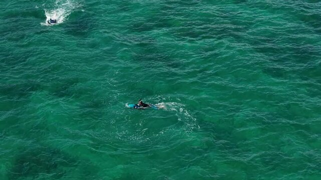 Riding an underwater scooter. Riding in the sea on a modern tugboat. Modern means of entertainment during a yacht vacation. View from a drone