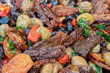 Mediterranean mix of sun-dried tomatoes, green and black olives, red peppers, and herbs — a colorful and savory antipasto.