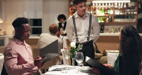 Couple, dating and waiter in restaurant with menu for order, romance or anniversary celebration. Hospitality, conversation and fine dining with man, woman and romantic dinner for valentines day