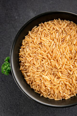 Brown rice whole grain cereal healthy product superfood fresh tasty gourmet food background on the table rustic food top view copy space keto and paleo diet vegetarian and vegan food