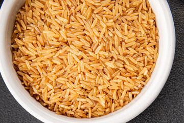 Brown rice whole grain cereal healthy product superfood fresh tasty gourmet food background on the table rustic food top view copy space keto and paleo diet vegetarian and vegan food