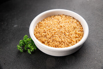 Brown rice whole grain cereal healthy product superfood fresh tasty gourmet food background on the table rustic food top view copy space keto and paleo diet vegetarian and vegan food