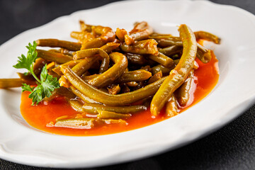 Green beans tomato sauce fresh delicious gourmet food background on the table rustic food top view copy space keto and paleo diet vegetarian and vegan food