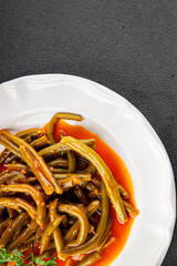 Green beans tomato sauce fresh delicious gourmet food background on the table rustic food top view copy space keto and paleo diet vegetarian and vegan food