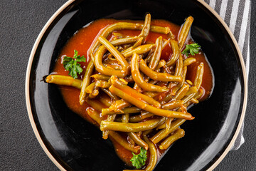Green beans tomato sauce fresh delicious gourmet food background on the table rustic food top view copy space keto and paleo diet vegetarian and vegan food