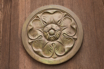 Italy, Calabria, Tropea. Bronze medallion with flower design.