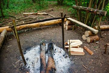 Equipped forest campsite with benches, fire pit and firewood supply