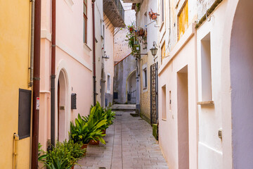 Fototapeta premium Italy, Basilicata, Maratea. Narrow walkway between buildings.