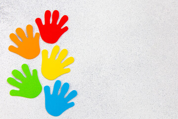 Colorful handprints arranged on a white background showcasing creativity and playfulness