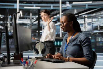 Annoyed data center engineer leaving after having fight with coworker over performance issues. Irritated woman in server farm departing from colleague desk after finishing dispute