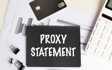 Proxy statement text on black paper with charts, credit card, calculator and office supplies
